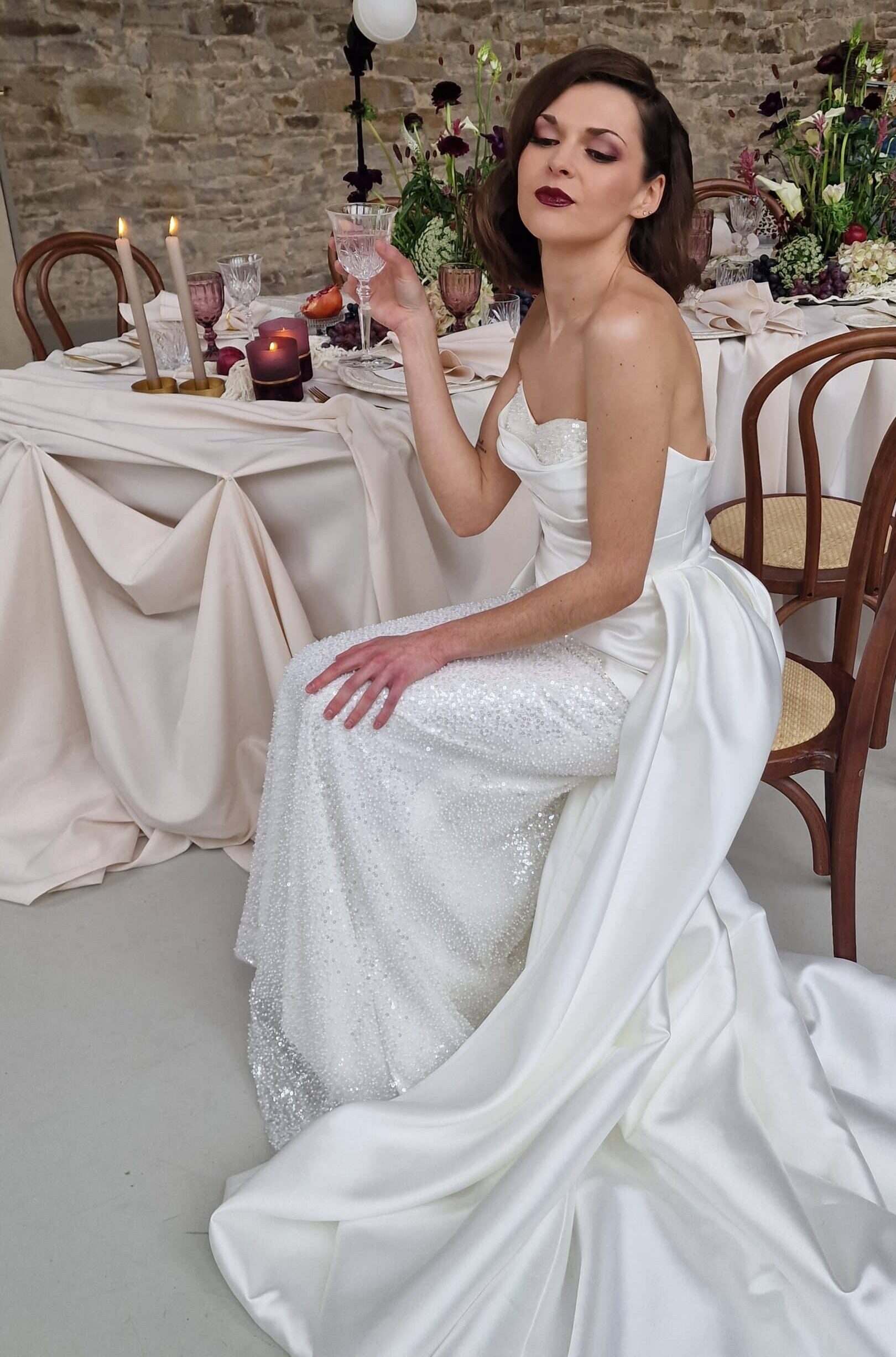 mediterrane hochzeit braut im kleid mit schleppe am tisch